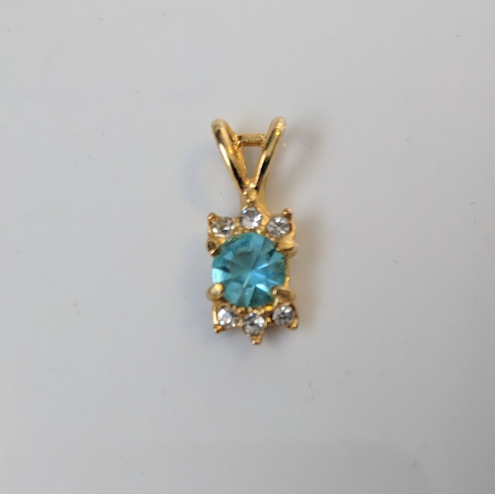 Gold tone with blue and clear stones
